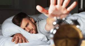 man waking up to alarm clock